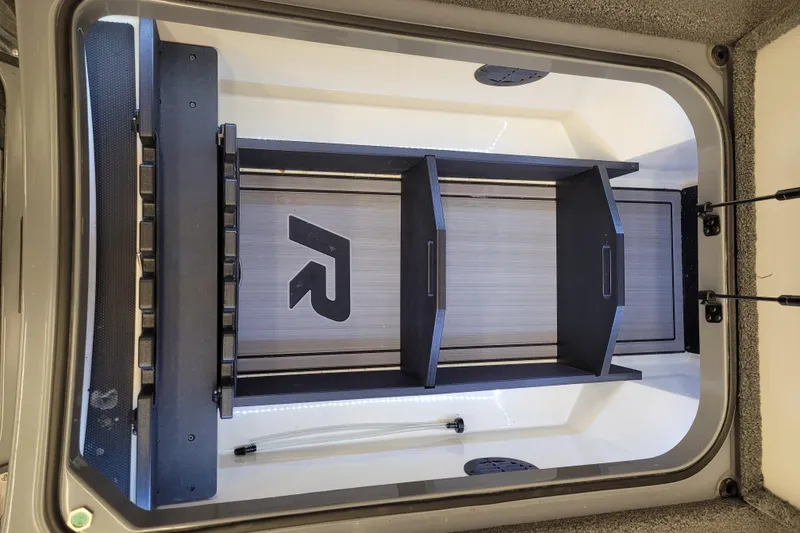 Slide: The Image of 2023 Ranger Z521R storage compartment with organized shelving and LED lighting. - 19