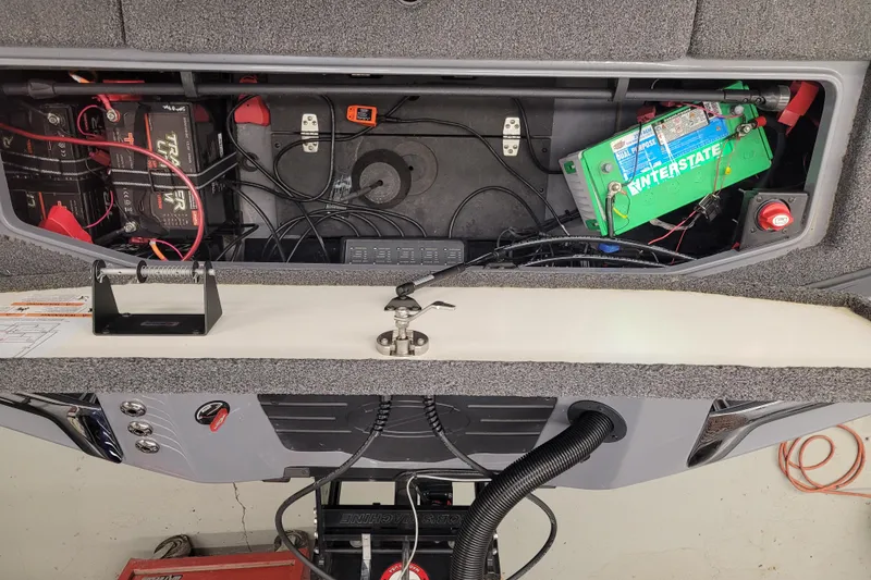 Slide: The Image of 2023 Ranger Z521R boat battery compartment with wiring and Interstate battery. - 2