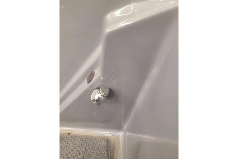 Slide: The Image of 2023 Ranger Z521R boat interior detail with chrome fixture and textured flooring. - 23