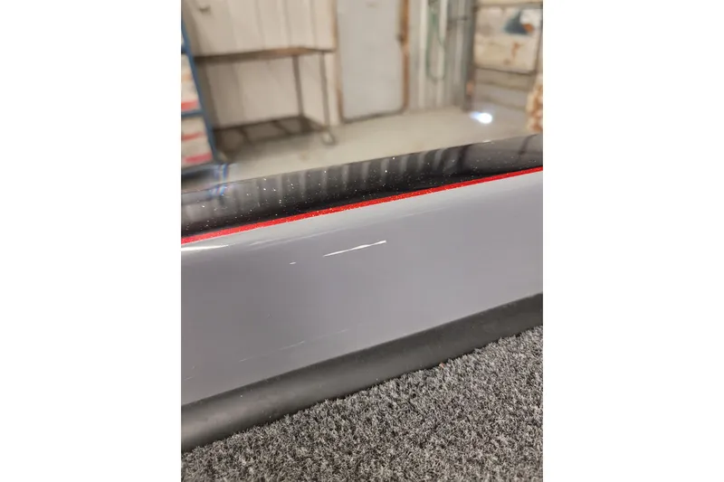 Slide: The Image of 2023 Ranger Z521R boat with a visible scratch on the gray surface. - 25