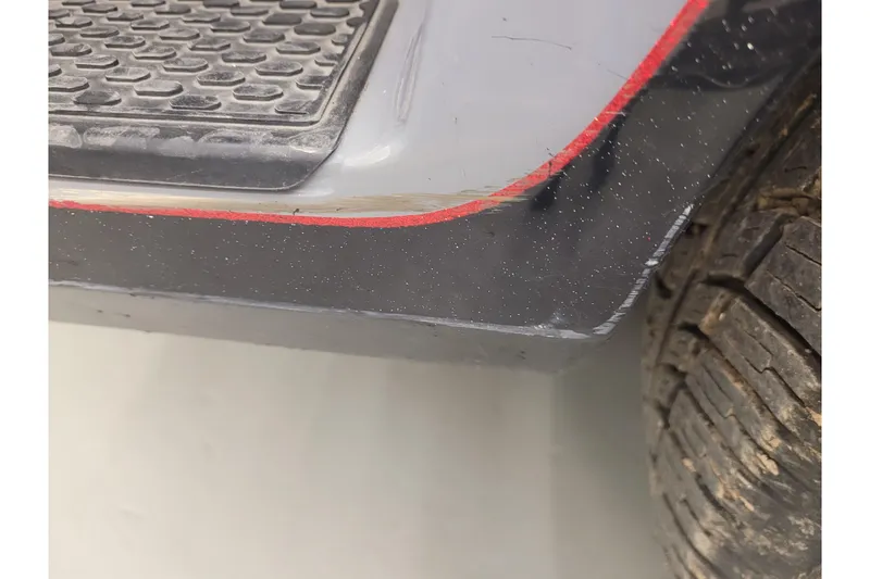 Slide: The Image of Close-up of 2023 Ranger Z521R vehicle's side with red trim and tire detail. - 31
