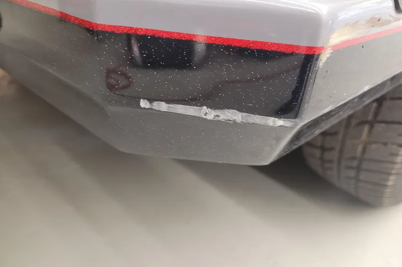 Slide: The Image of 2023 Ranger Z521R with minor scratch on black exterior near rear tire. - 32