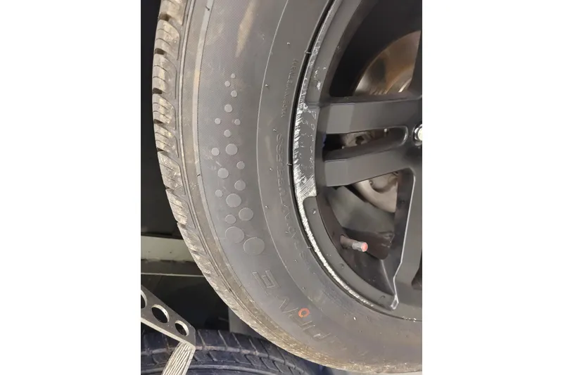 Slide: The Image of 2023 Ranger Z521R tire with black alloy wheel and visible tread pattern. - 33