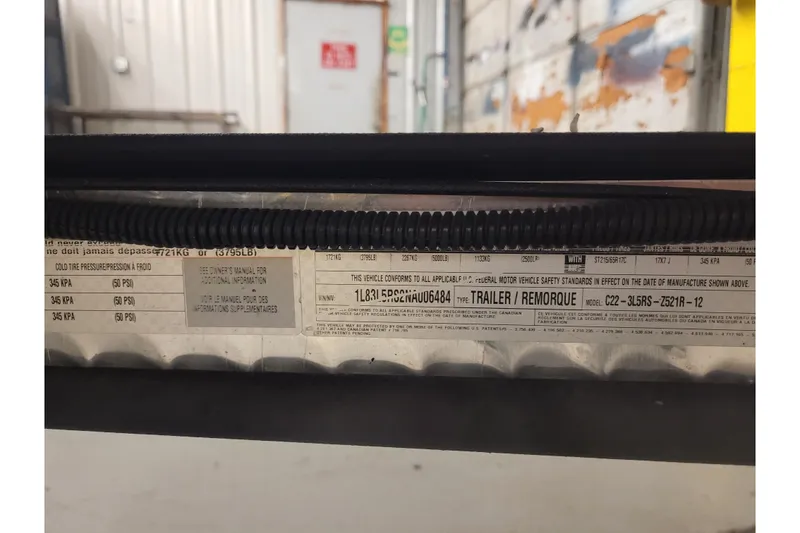 Slide: The Image of 2023 Ranger Z521R trailer label with specifications and safety standards. - 39