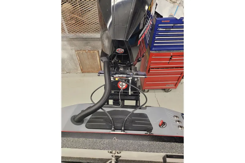 Slide: The Image of 2023 Ranger Z521R boat engine with tool chest in garage setting. - 4