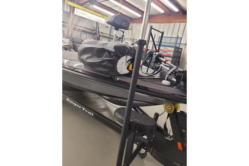 Slide: The Image of 2023 Ranger Z521R boat in a garage, featuring a covered motor and trailer. - 40