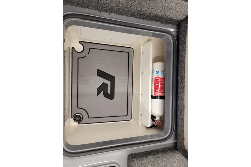 Slide: The Image of 2023 Ranger Z521R storage compartment with fire extinguisher and branded cover. - 5