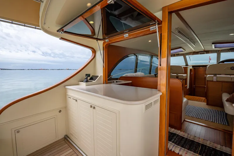 Slide: The Image of Luxurious 2020 Palm Beach Motor Yachts PB50 interior with elegant wood finishes and ocean view. - 12