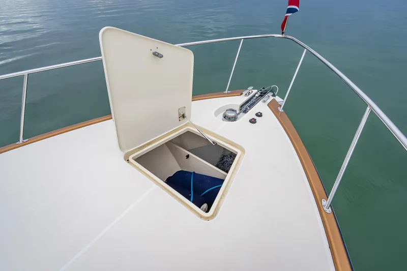 Slide: The Image of Open hatch on 2020 Palm Beach Motor Yachts PB50 deck, revealing storage compartment. - 16