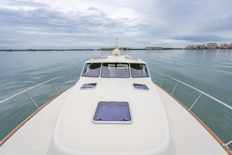 Slide: The Image of 2020 Palm Beach Motor Yachts PB50 cruising on calm waters under cloudy skies. - 17