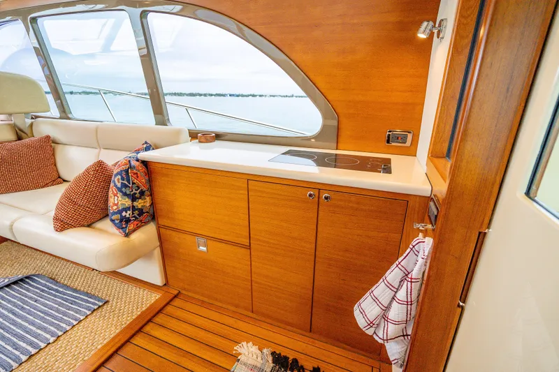 Slide: The Image of Luxurious interior of 2020 Palm Beach Motor Yachts PB50 with elegant wood finish and cozy seating. - 23