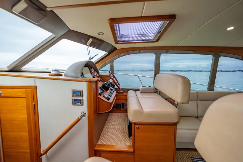 Slide: The Image of Interior of 2020 Palm Beach Motor Yachts PB50, featuring luxurious seating and elegant wood finishes. - 29