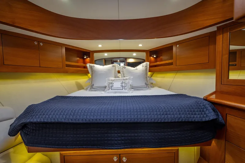 Slide: The Image of Luxurious 2020 Palm Beach Motor Yachts PB50 cabin with elegant bedding and wooden accents. - 34