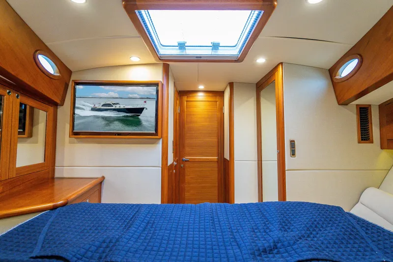 Slide: The Image of Luxurious 2020 Palm Beach Motor Yachts PB50 cabin interior with wood accents and skylight. - 36