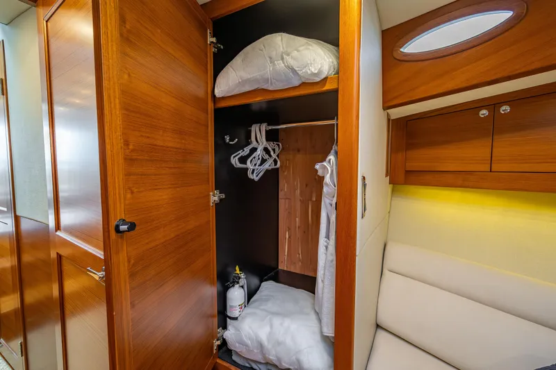 Slide: The Image of 2020 Palm Beach Motor Yachts PB50 interior closet with wooden finish and storage space. - 37