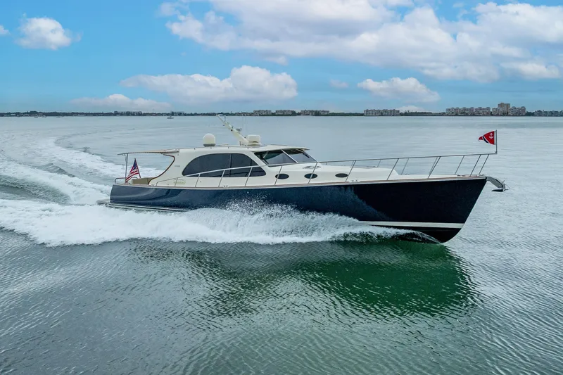 Slide: The Image of 2020 Palm Beach Motor Yachts PB50 cruising on calm waters under a cloudy sky. - 5