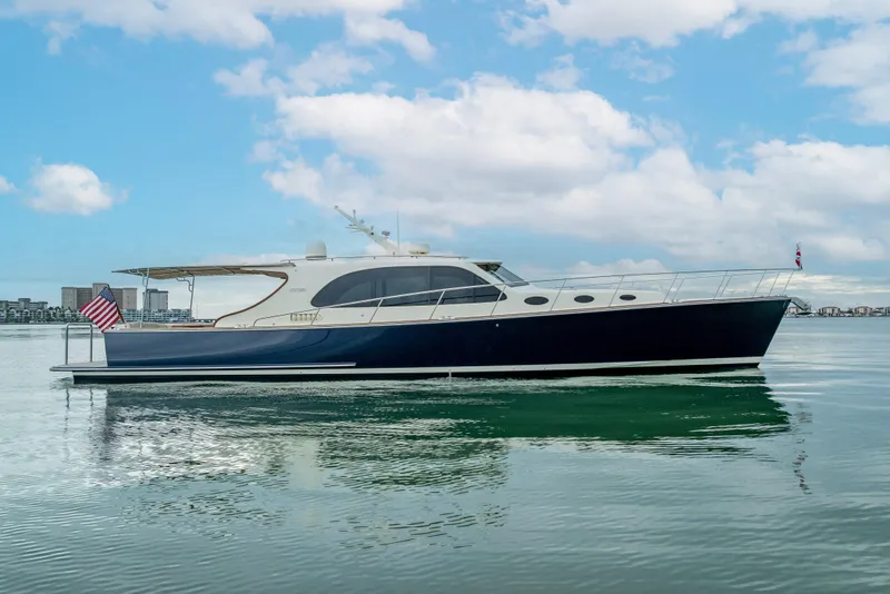 The Image of 2020 Palm Beach Motor Yachts PB50 on calm water under a blue sky. - 0