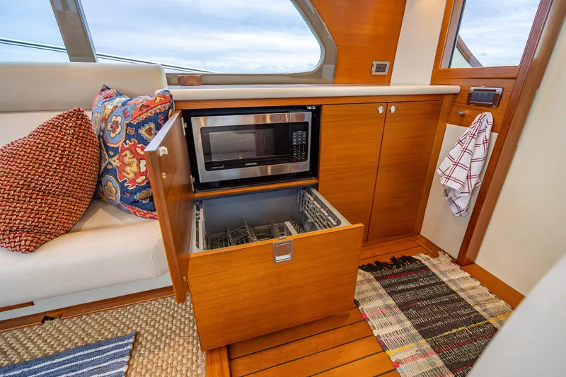 Slide: The Image of Luxurious 2020 Palm Beach Motor Yachts PB50 interior with microwave and dishwasher in wooden cabinetry. - 24