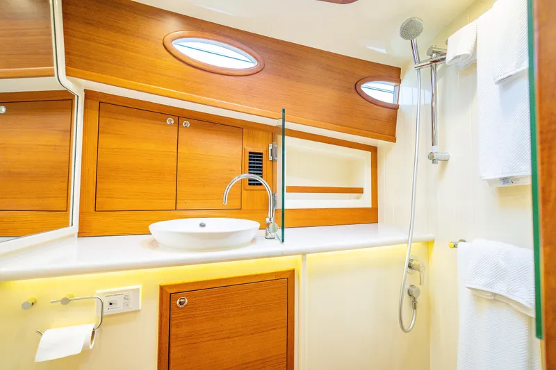 Slide: The Image of Luxurious bathroom in 2020 Palm Beach Motor Yachts PB50, featuring elegant wood finishes and modern fixtures. - 38