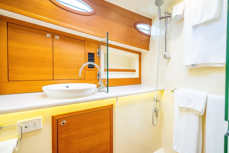 Slide: The Image of Luxurious bathroom in 2020 Palm Beach Motor Yachts PB50, featuring elegant wood cabinetry and modern fixtures. - 39