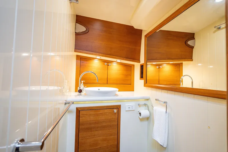 Slide: The Image of Luxurious 2020 Palm Beach Motor Yachts PB50 bathroom with wood accents and modern fixtures. - 40