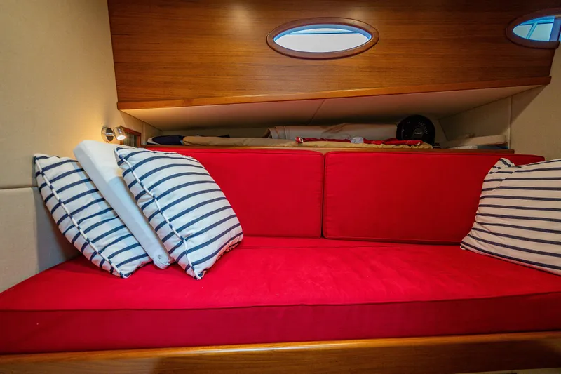 Slide: The Image of 2020 Palm Beach Motor Yachts PB50 interior with red seating and striped pillows. - 42