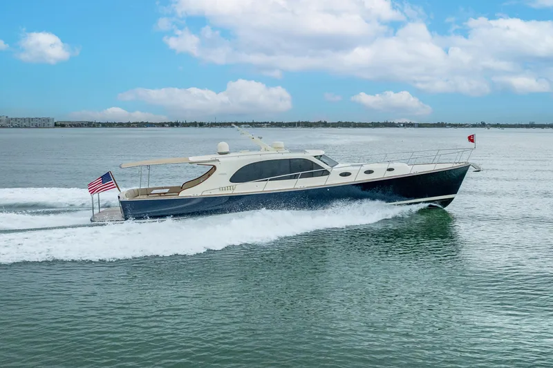 Slide: The Image of 2020 Palm Beach Motor Yachts PB50 cruising on calm waters under a blue sky. - 46