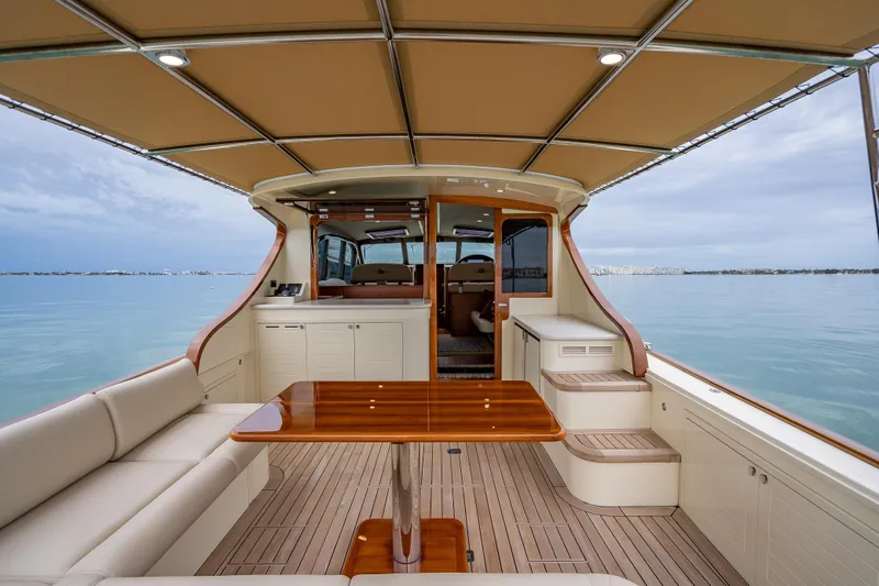 Slide: The Image of Luxurious 2020 Palm Beach Motor Yachts PB50 interior with elegant seating and wooden table. - 8