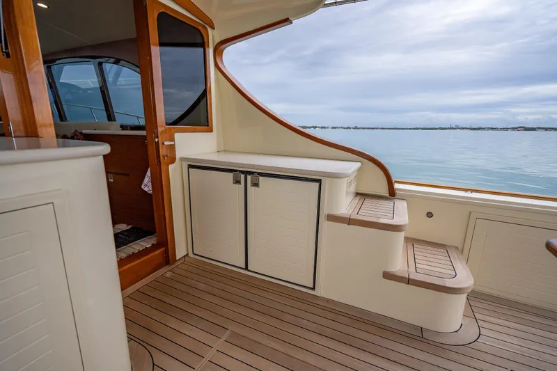 Slide: The Image of Luxurious 2020 Palm Beach Motor Yachts PB50 interior with elegant wood finish and ocean view. - 9