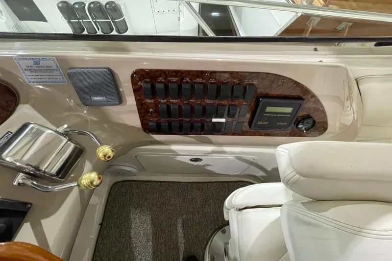 Slide: The Image of Control panel of a 2001 Sea Ray Sundancer 460 yacht, featuring switches and system monitor. - 19
