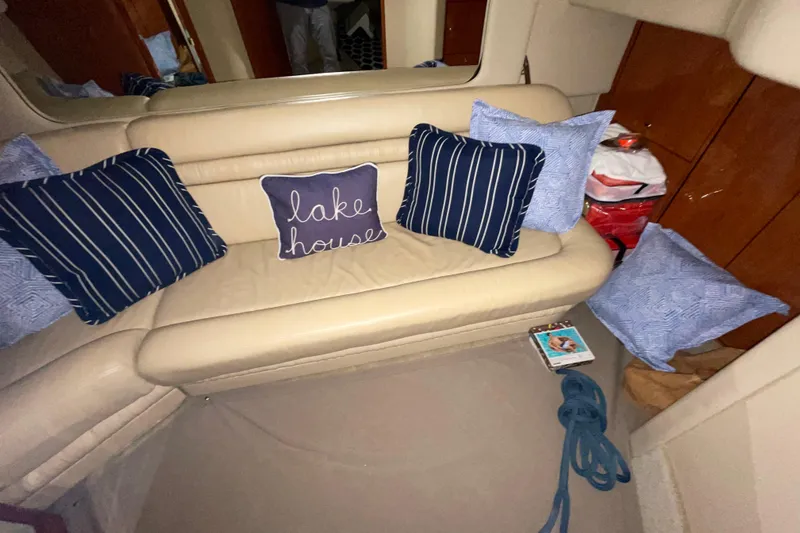 Slide: The Image of Interior of 2001 Sea Ray Sundancer 460 with cozy seating and decorative pillows. - 21