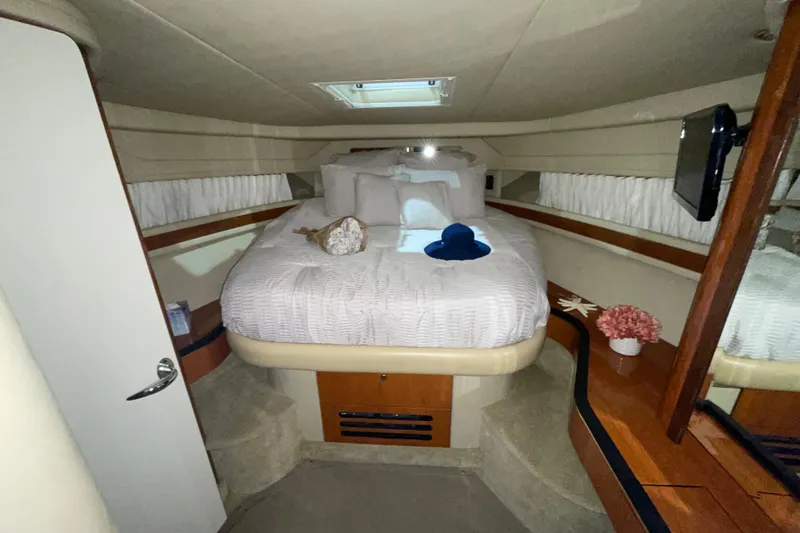 Slide: The Image of Luxurious cabin interior of 2001 Sea Ray Sundancer 460 yacht with cozy bed and decor. - 24