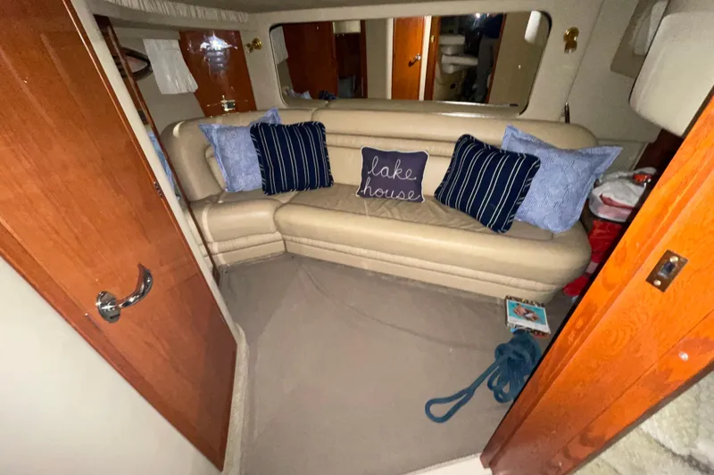 Slide: The Image of Interior of 2001 Sea Ray Sundancer 460 with beige seating and decorative pillows. - 25