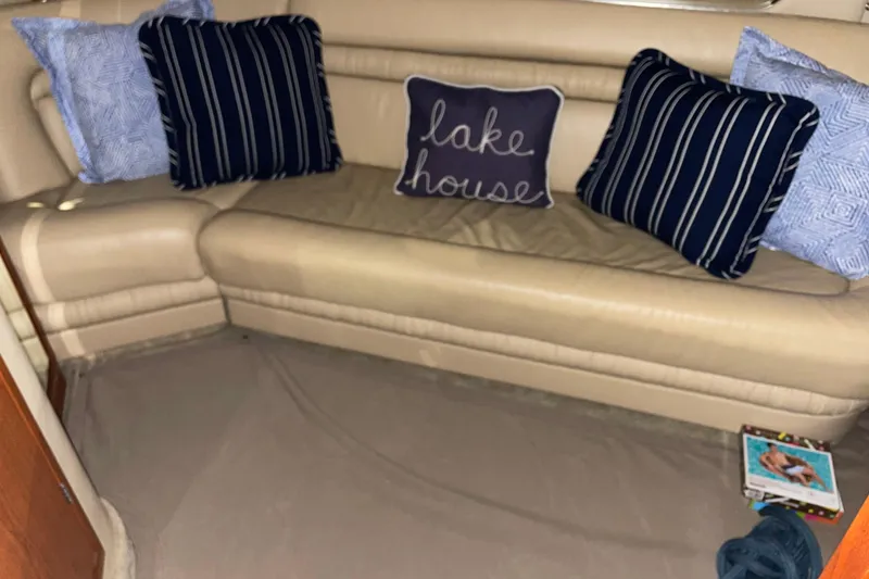 Slide: The Image of Interior of 2001 Sea Ray Sundancer 460 with cozy cushions and "lake house" pillow. - 26