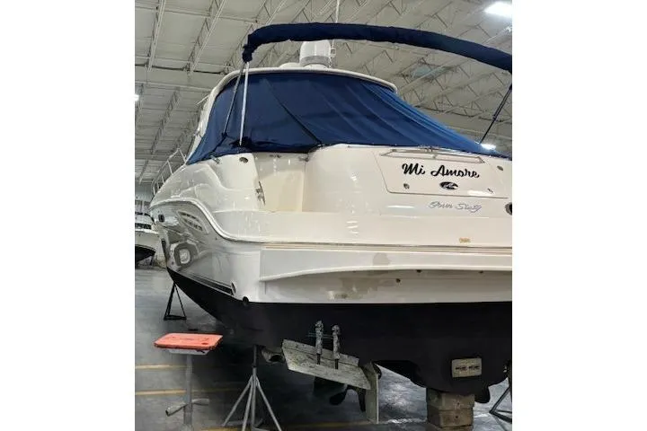 Slide: The Image of 2001 Sea Ray 460 Sundancer yacht in storage, rear view with blue cover. - 8