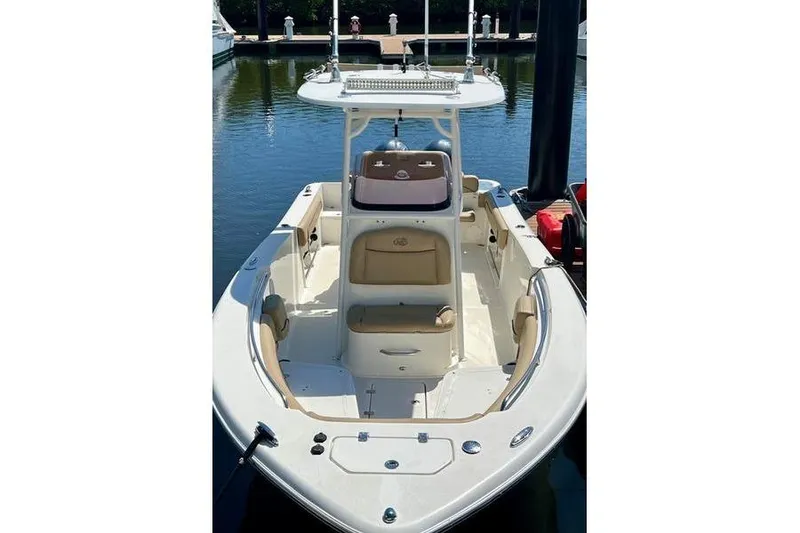 Slide: The Image of 2019 NauticStar 25 XS boat docked, featuring spacious seating and sleek design. - 3