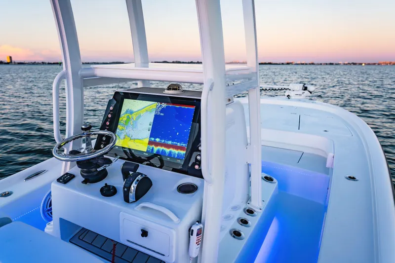 Slide: The Image of 2026 Barker Boatworks 26 Calibogue Bay helm with advanced navigation system at sunset. - 3