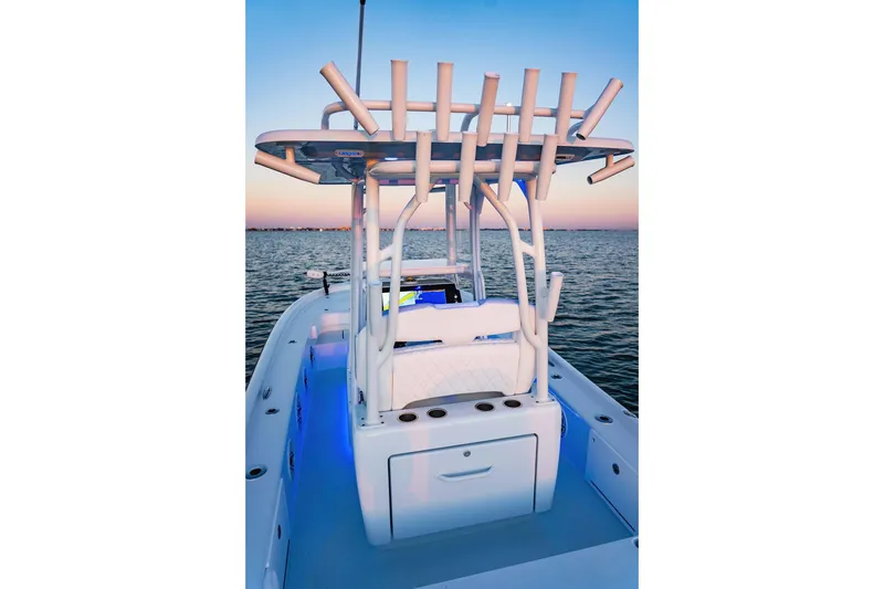 Slide: The Image of 2026 Barker Boatworks 26 Calibogue Bay on water at sunset, featuring rod holders and seating. - 4