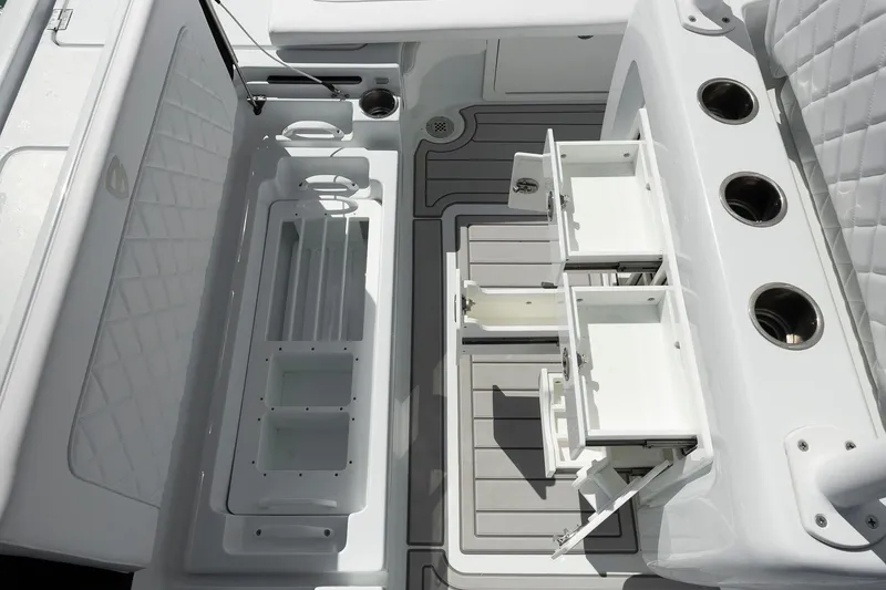 Slide: The Image of 2026 Barker Boatworks 26 Calibogue Bay interior with storage compartments and rod holders. - 6