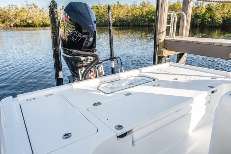 Slide: The Image of 2026 Barker Boatworks 26 Calibogue Bay with powerful outboard motor on calm water. - 7
