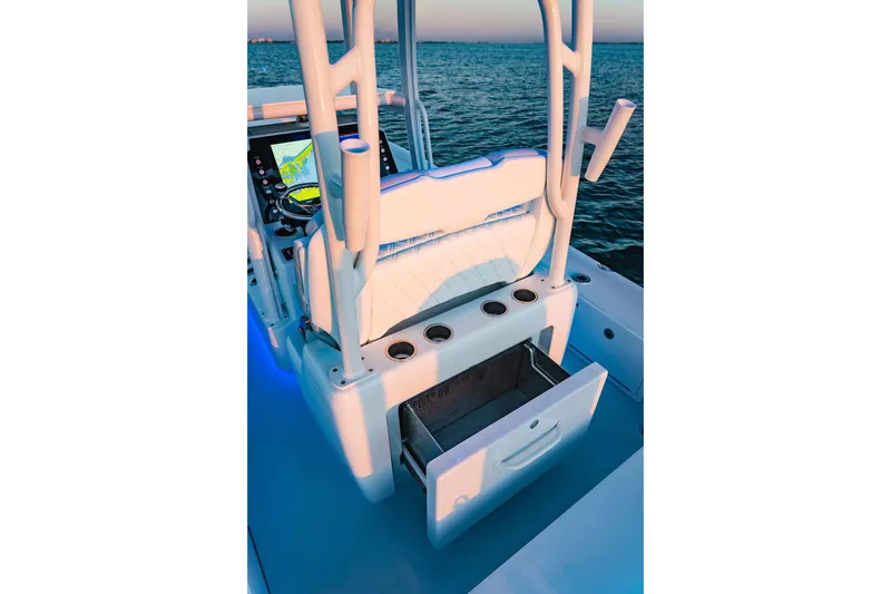 Slide: The Image of 2026 Barker Boatworks 26 Calibogue Bay interior with open storage drawer, ocean view. - 5