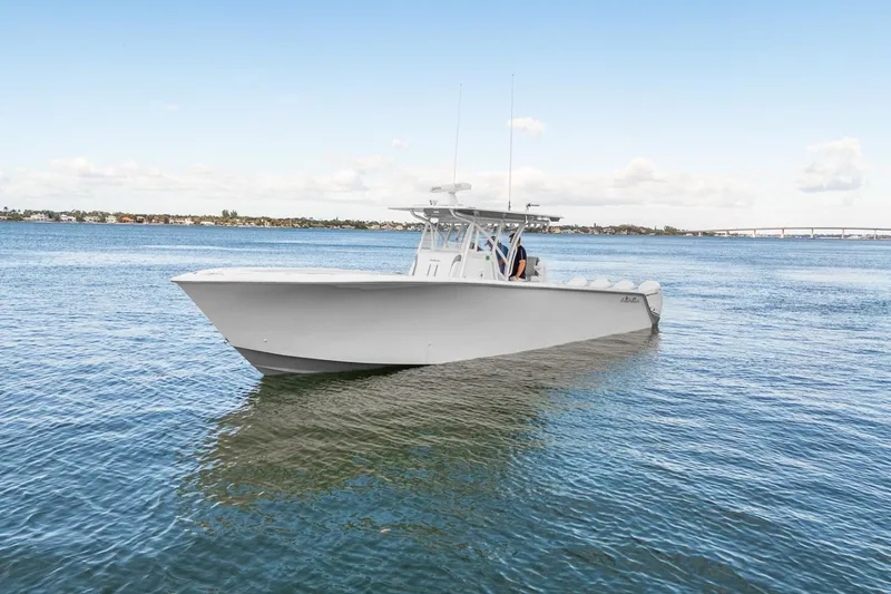 Slide: The Image of 2021 SeaHunter 39 Tournament boat on calm water under clear sky. - 14