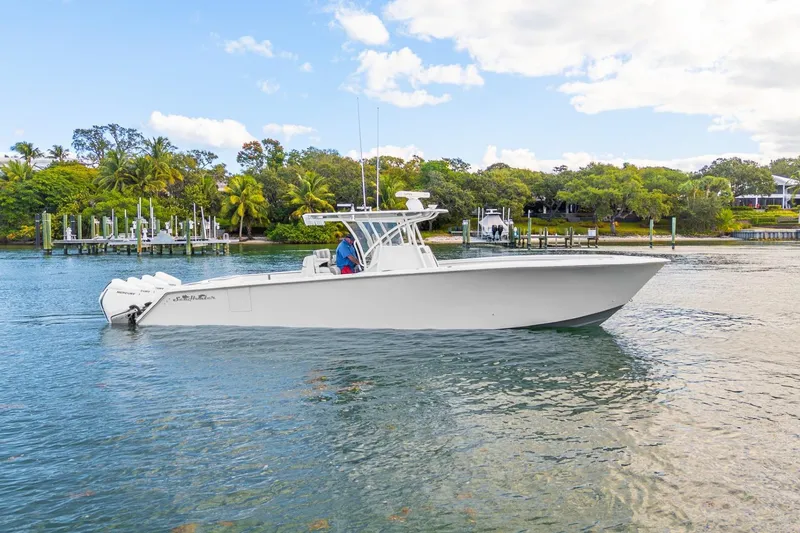Slide: The Image of 2021 SeaHunter 39 Tournament boat cruising on a scenic waterway. - 15