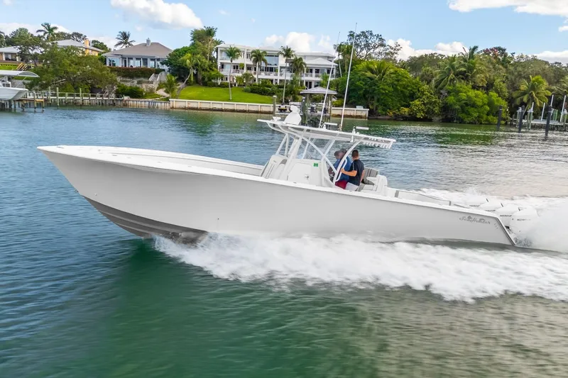 Slide: The Image of 2021 SeaHunter 39 Tournament boat cruising on a scenic waterway. - 16