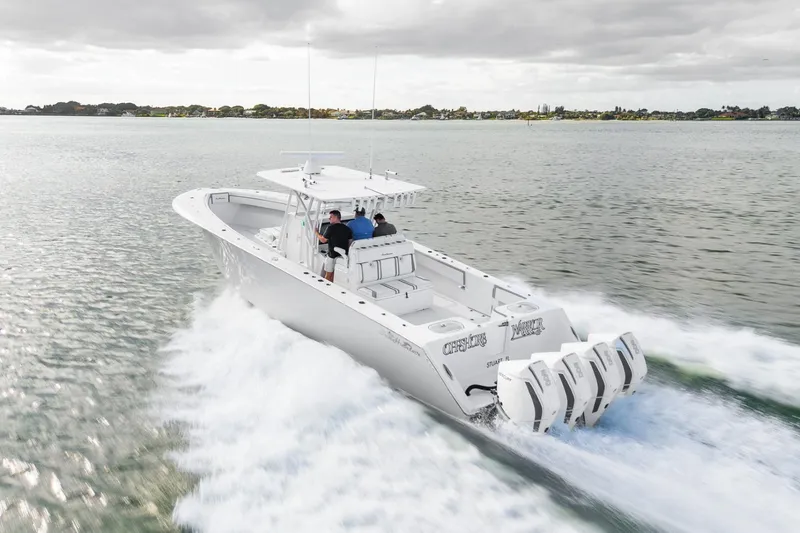 Slide: The Image of 2021 SeaHunter 39 Tournament boat cruising on open water, featuring four powerful engines. - 18