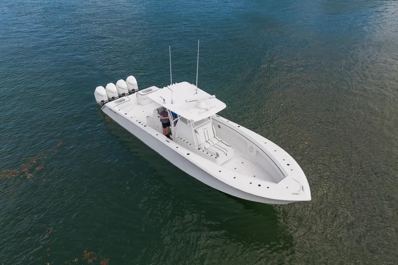 Slide: The Image of 2021 SeaHunter 39 Tournament boat on calm water, featuring four powerful outboard engines. - 2