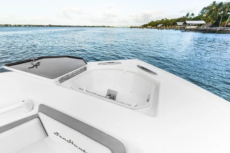 Slide: The Image of 2021 SeaHunter 39 Tournament boat on calm water, featuring open hatch and scenic shoreline. - 3