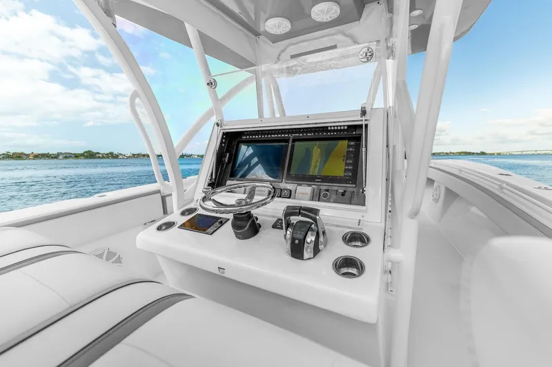 Slide: The Image of 2021 SeaHunter 39 Tournament boat cockpit with advanced navigation system, steering wheel, and ocean view. - 9