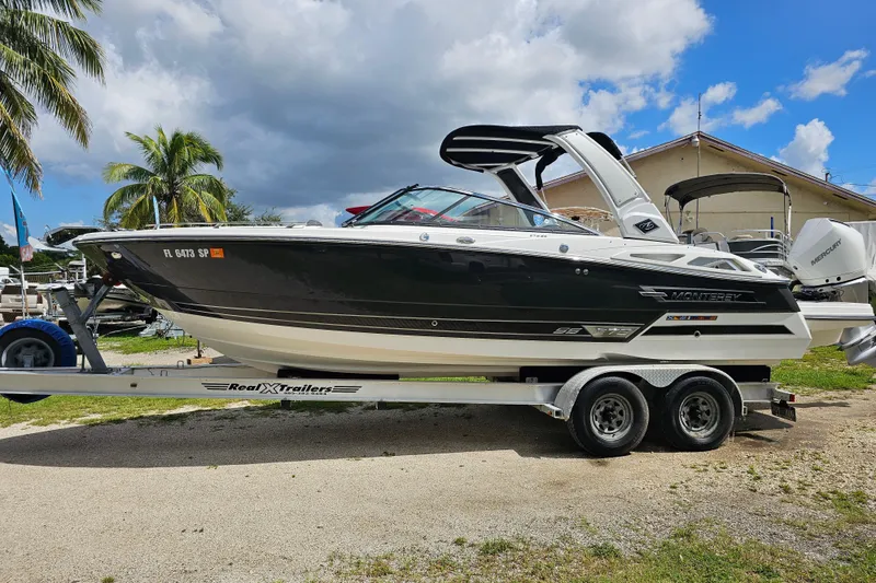 Slide: The Image of 2020 Monterey 275SS Super Sport boat on trailer, parked outdoors under cloudy sky. - 10