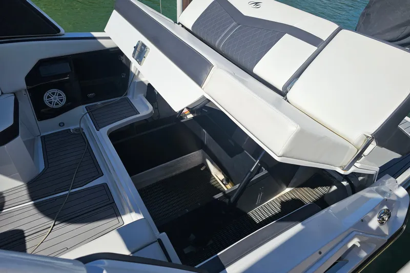 Slide: The Image of 2020 Monterey 275SS Super Sport boat interior with open storage compartment. - 11